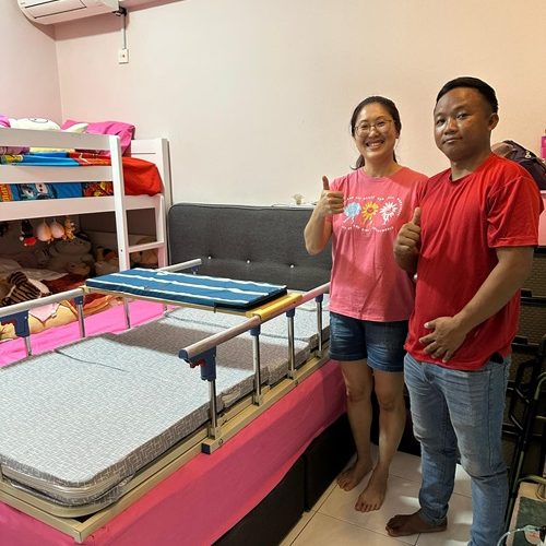 Happy couple with new hospital bed with safety rails