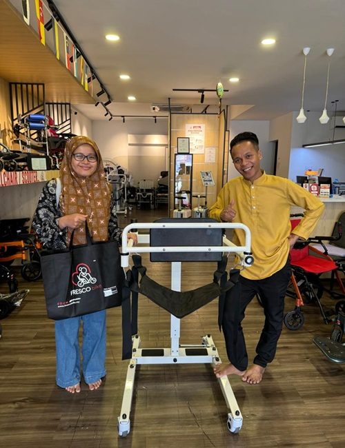 Happy customers with a new Fresco Bike patient lift in a mobility store.