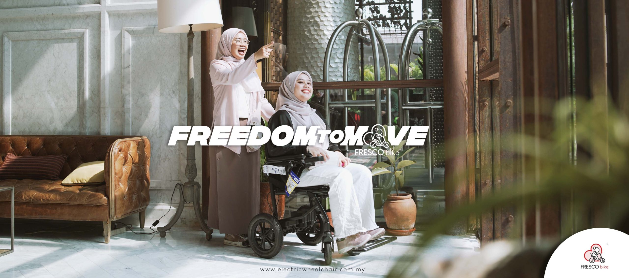 Two women, one in a wheelchair and the other standing beside her, smile in a well-lit room. A large text overlay reads "FREEDOM TO MOVE," and the logo "FRESCO" is visible at the bottom right.