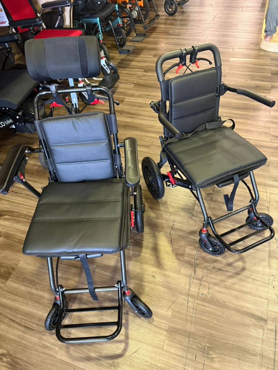 Two lightweight Fresco Bike travel wheelchairs, ideal for portability and ease of transport.