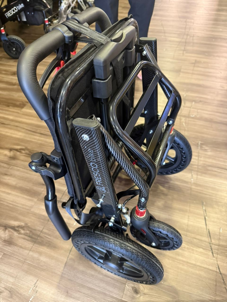 Fresco Bike travel wheelchair folded, showing lightweight, compact design. Ideal portable wheelchair for travel.