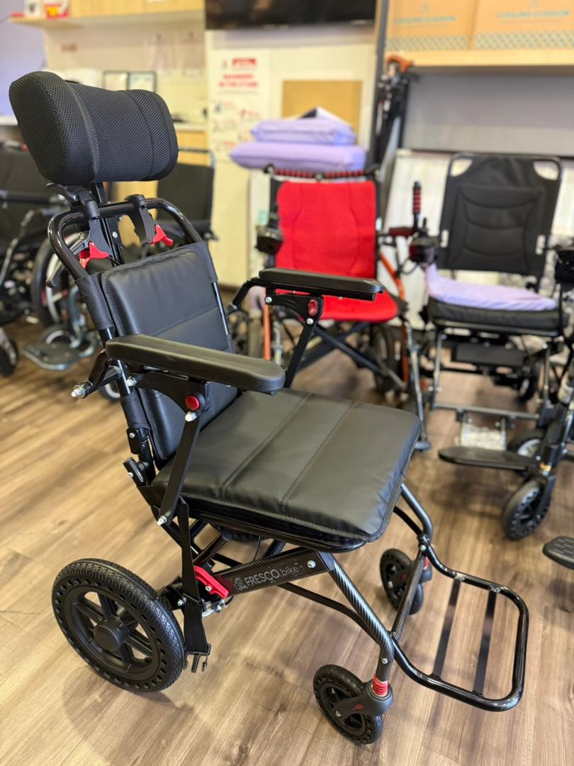 Fresco Bike travel wheelchair: lightweight, portable design with headrest.