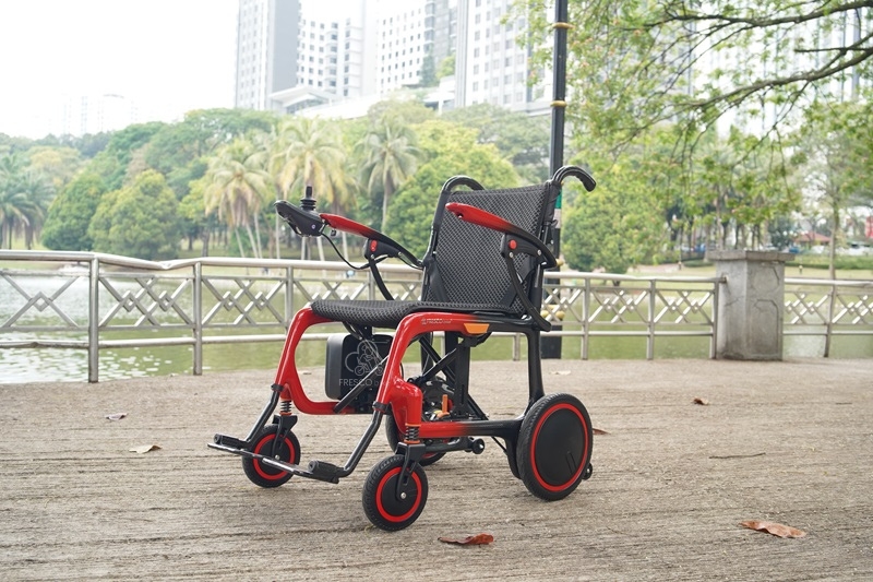 Lightweight carbon fiber electric wheelchair outdoors.